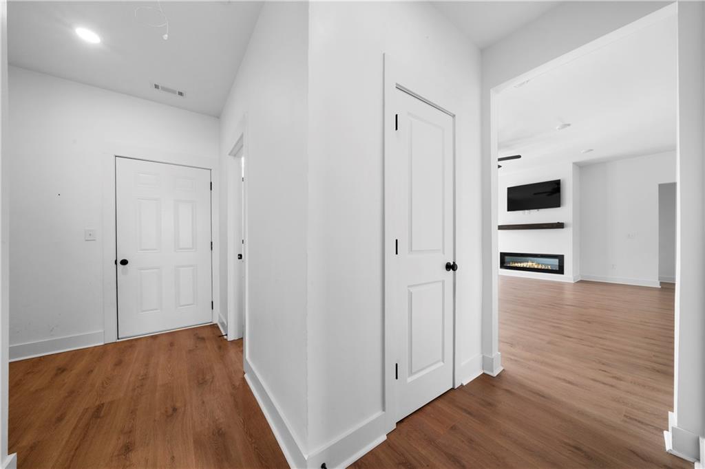 19 Trotters Lane Rome, GA 30165 - Photo 31 of 44 a view of a hallway with wooden floor and closet area