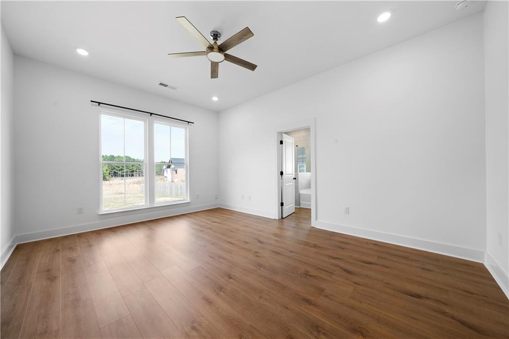 19 Trotters Lane Rome, GA 30165 - Photo 32 of 44 a view of an empty room with wooden floor and a window