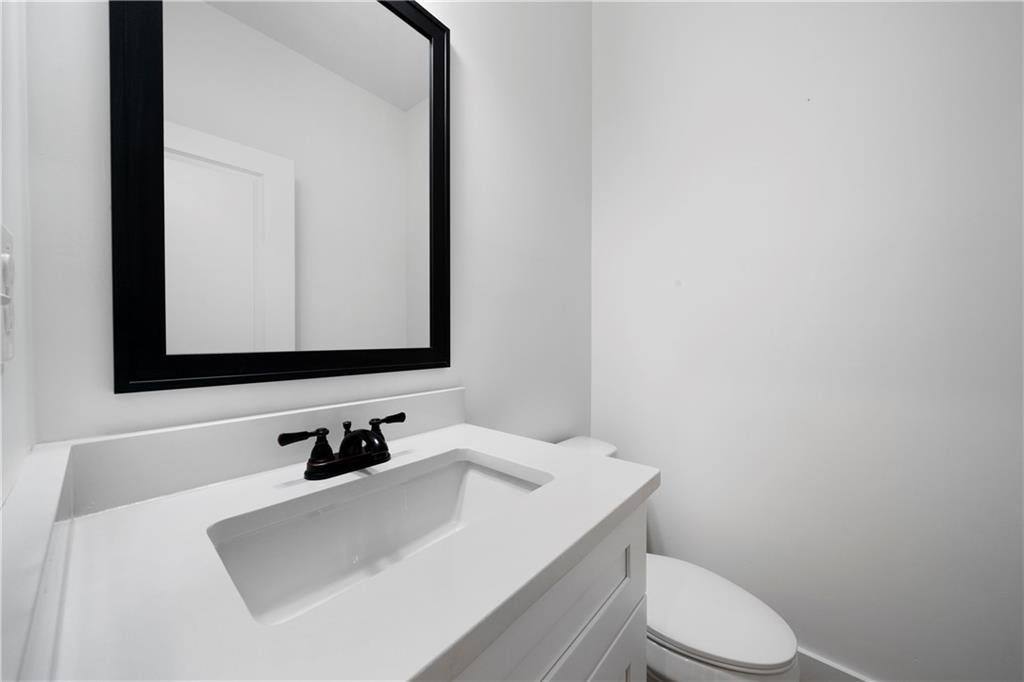 19 Trotters Lane Rome, GA 30165 - Photo 42 of 44 a bathroom with a sink a toilet and mirror