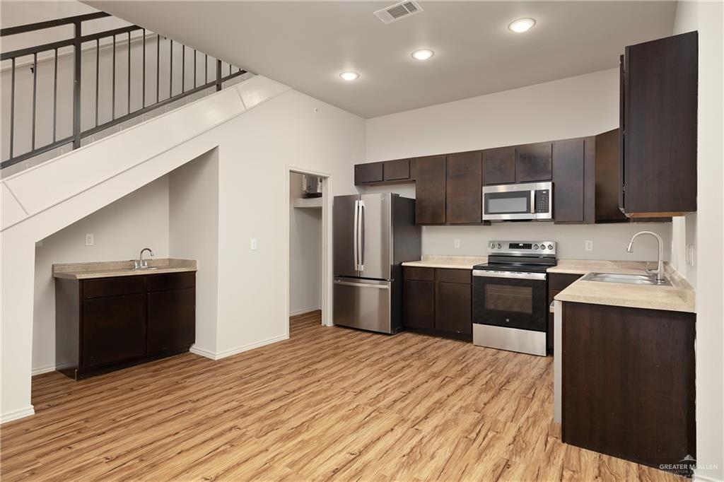 810 South Taylor Road Mission, TX 78572 - Photo 12 of 17 a kitchen with stainless steel appliances kitchen island granite countertop a refrigerator stove top oven and sink