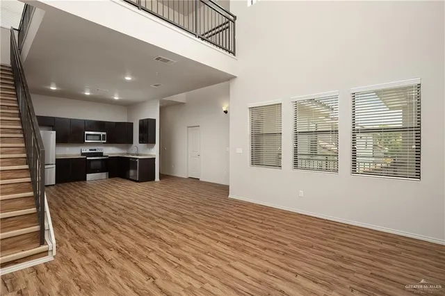 a kitchen with stainless steel appliances kitchen island granite countertop a refrigerator stove top oven and sink