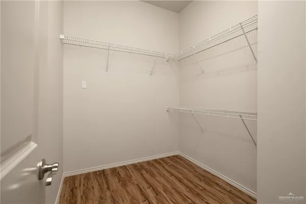 an empty room with ceiling fan and window