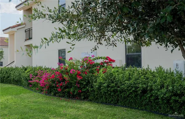 a view of a flower garden in front of a house