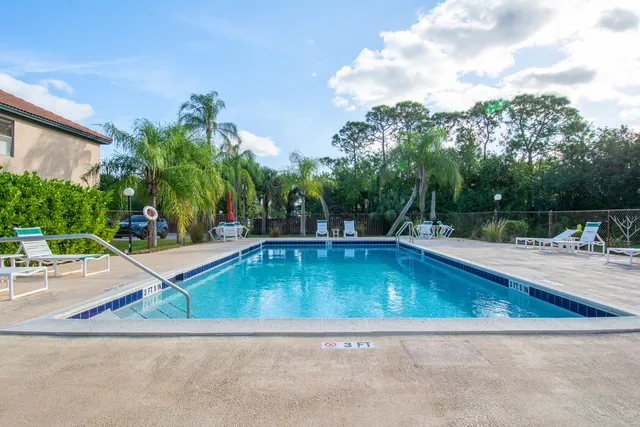 a view of swimming pool with outdoor seating and plants