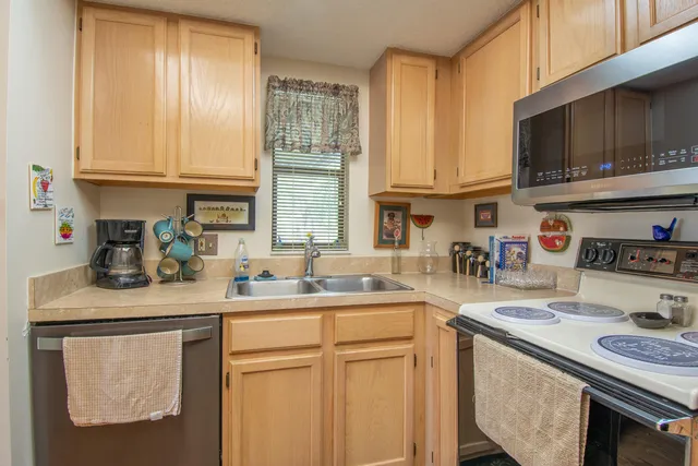 a kitchen with stainless steel appliances granite countertop a sink stove and cabinets