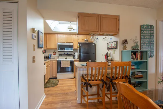 a kitchen with stainless steel appliances a refrigerator and a stove top oven