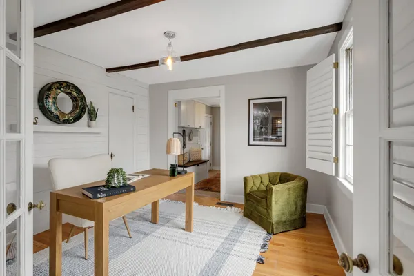 a living room with furniture and a clock