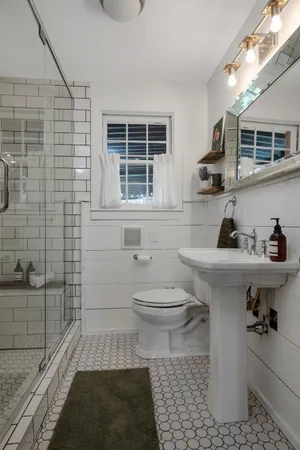 a bathroom with a toilet and a shower