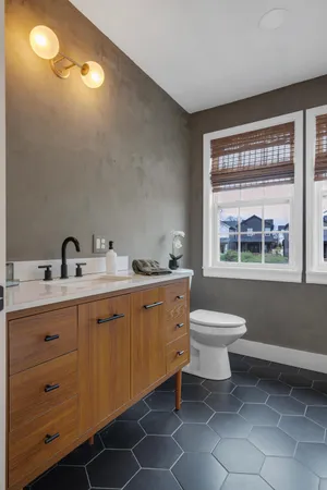 a spacious bathroom with a toilet sink and mirror