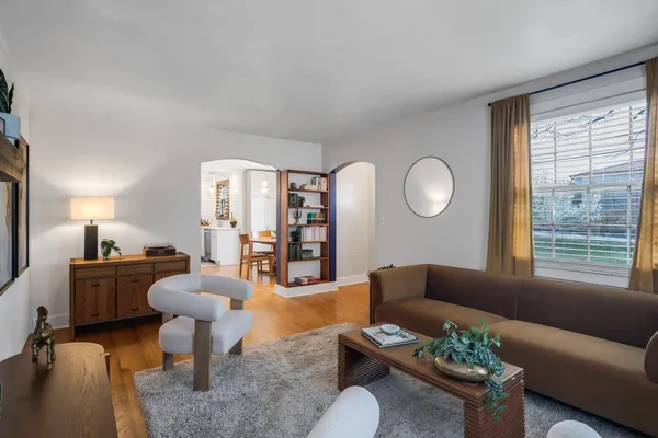 a living room with furniture a rug and a large window
