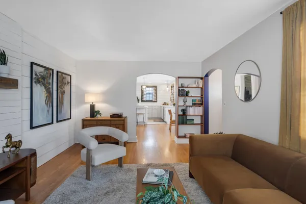 a living room with furniture and wooden floor