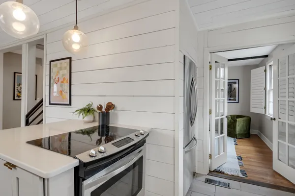 a kitchen with a sink and chandelier