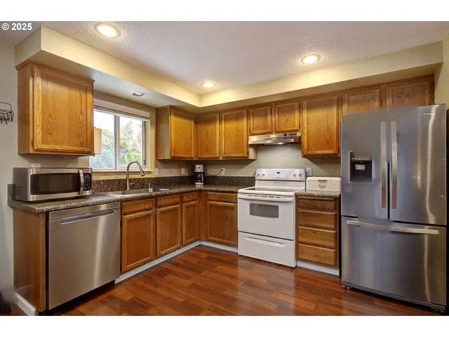 a kitchen with a refrigerator stove and sink