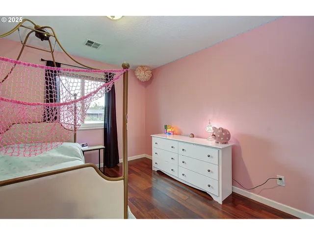 a bedroom with a bed and large windows