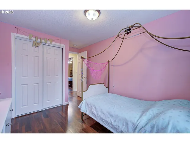 a bedroom with a bed and a chandelier fan