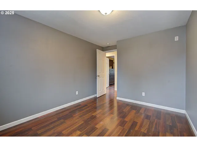 a view of an empty room and wooden floor