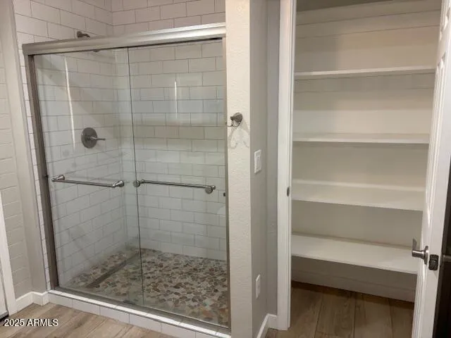 a bathroom with a glass shower door