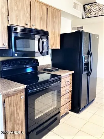 a kitchen with stainless steel appliances granite countertop a stove and a refrigerator