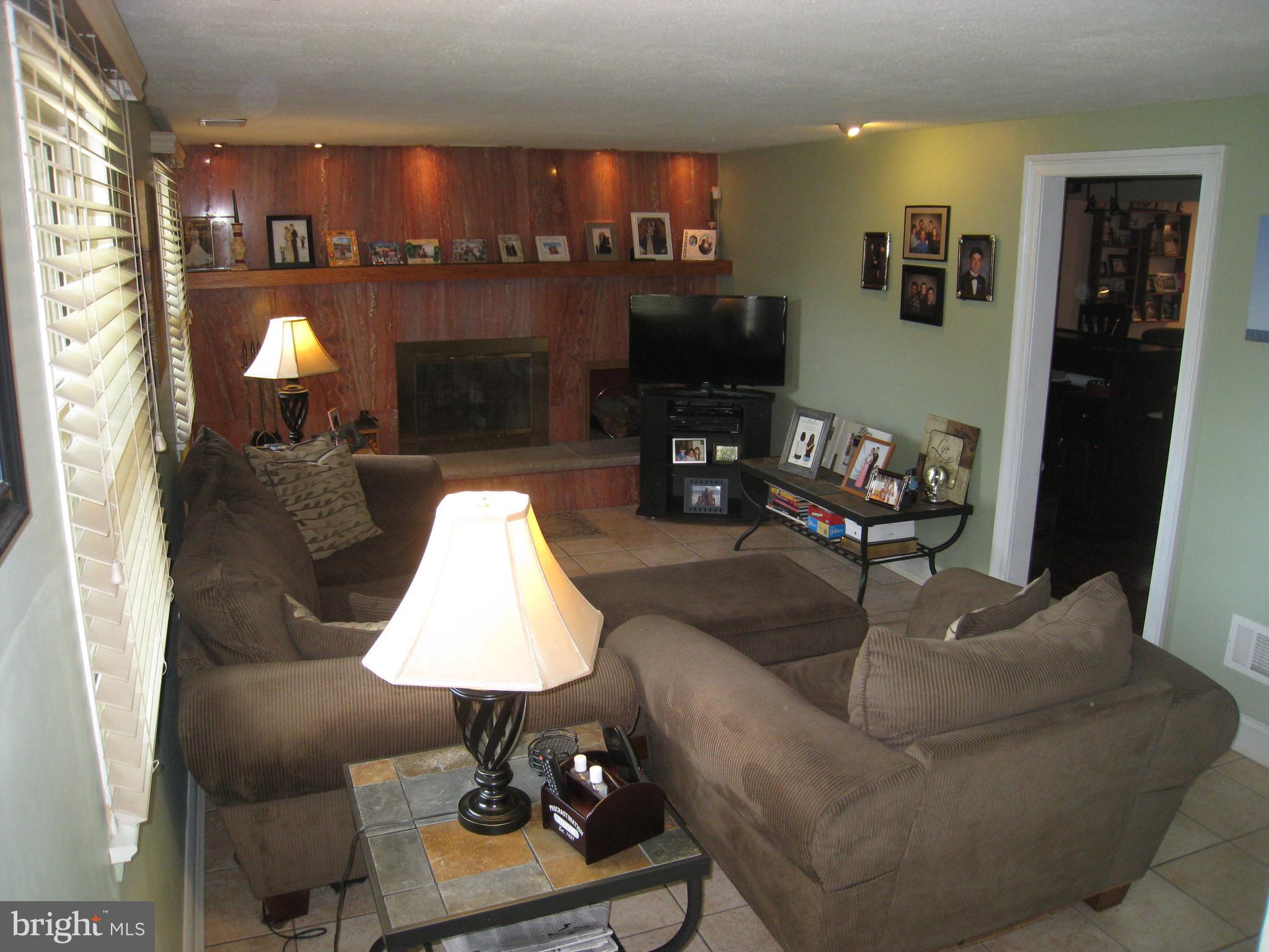 29 Buttonwood Road Stratford, NJ 08084 - Photo 13 of 45 a living room with furniture and a fireplace