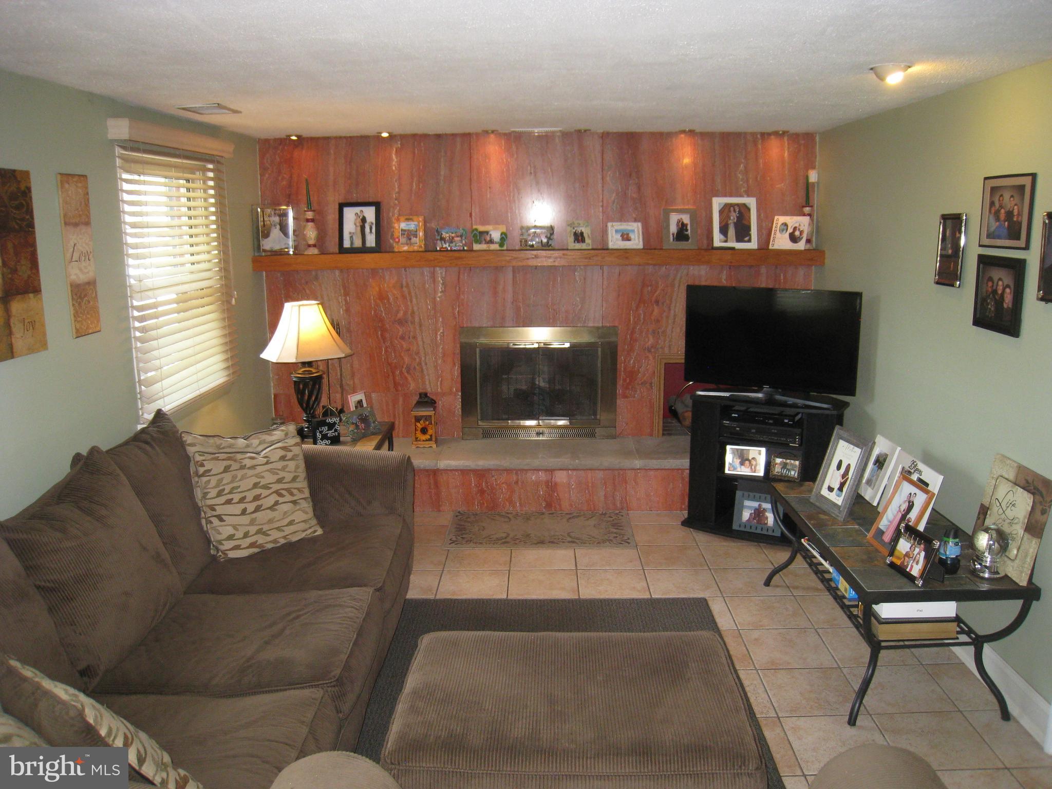 29 Buttonwood Road Stratford, NJ 08084 - Photo 14 of 45 a living room with furniture and a flat screen tv