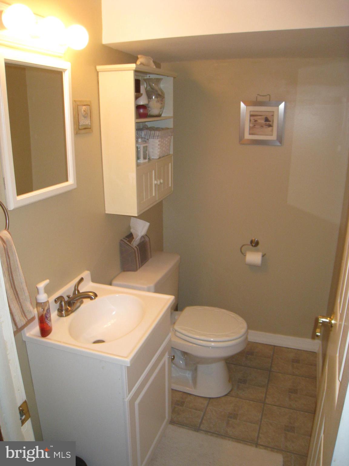 29 Buttonwood Road Stratford, NJ 08084 - Photo 19 of 45 a bathroom with a sink a toilet and a mirror