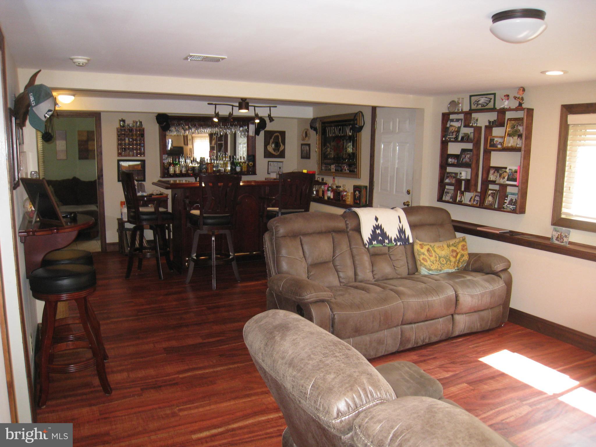 29 Buttonwood Road Stratford, NJ 08084 - Photo 20 of 45 a living room with furniture kitchen view and a wooden floor