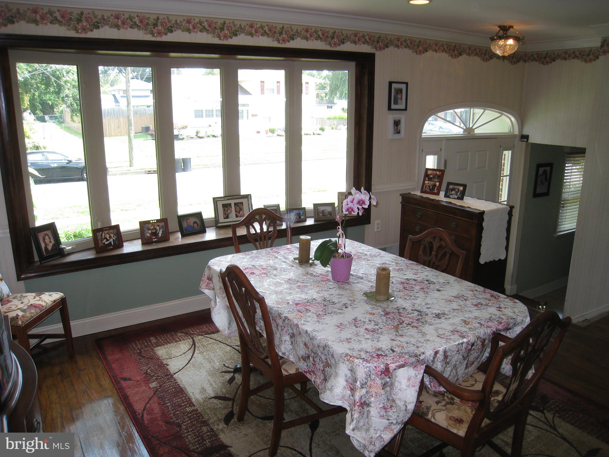 29 Buttonwood Road Stratford, NJ 08084 - Photo 29 of 45 a dining room with furniture a chandelier and wooden floor