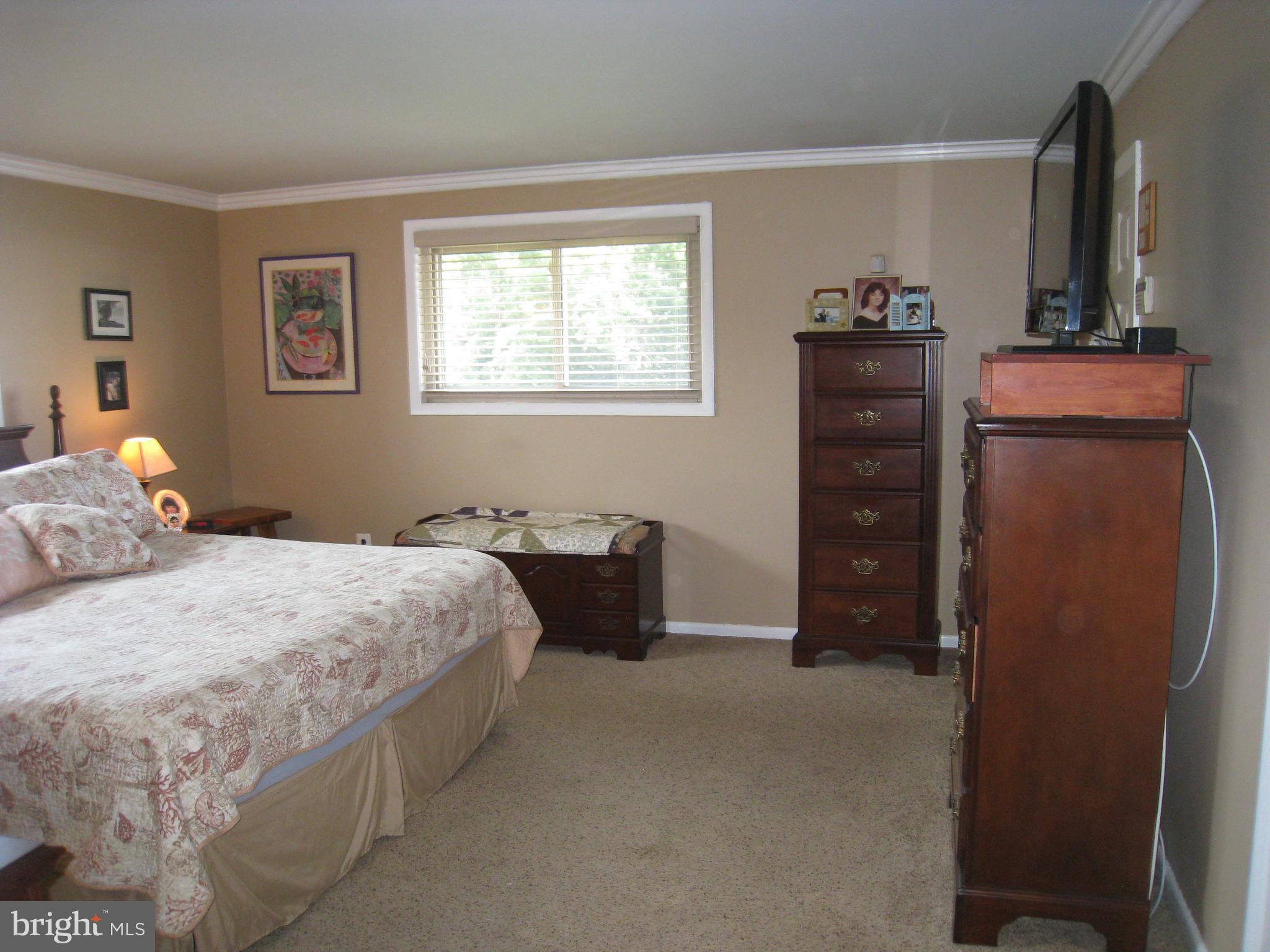 29 Buttonwood Road Stratford, NJ 08084 - Photo 31 of 45 a bedroom with a bed and a dresser