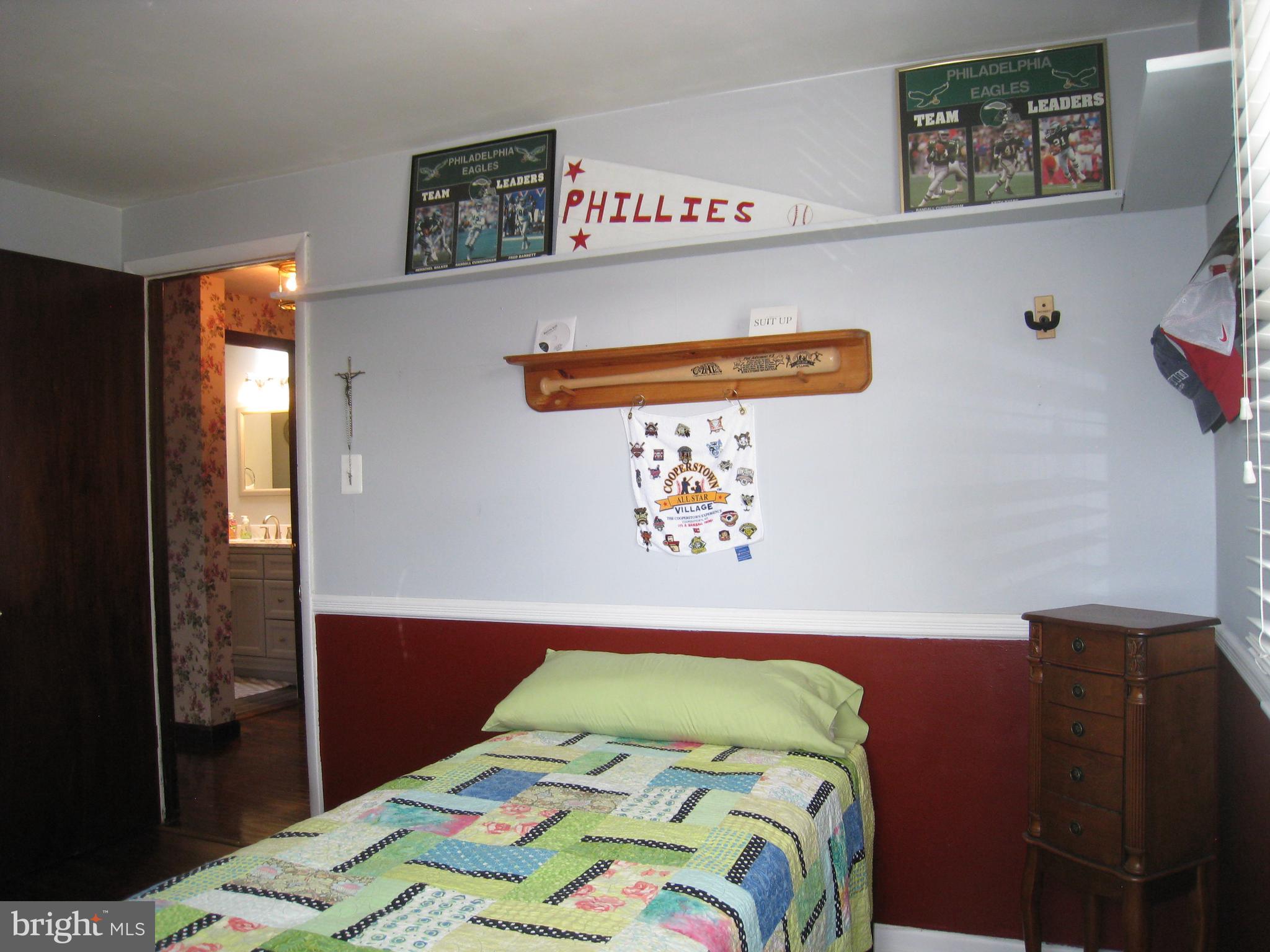 29 Buttonwood Road Stratford, NJ 08084 - Photo 38 of 45 a bedroom with a bed and painting on the wall