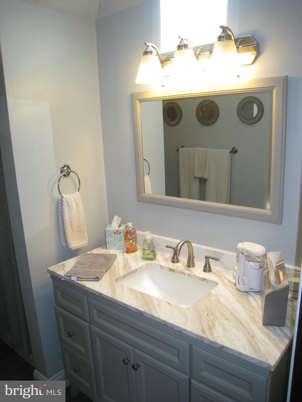29 Buttonwood Road Stratford, NJ 08084 - Photo 41 of 45 a bathroom with a sink and mirror