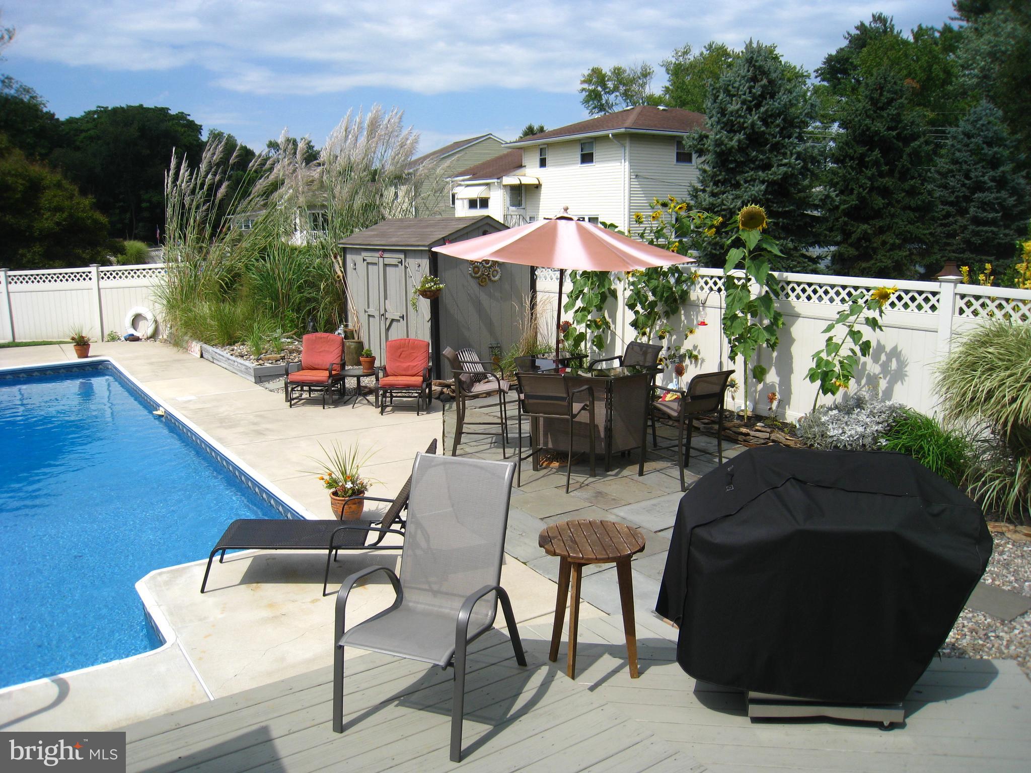 29 Buttonwood Road Stratford, NJ 08084 - Photo 6 of 45 a view of backyard with outdoor seating and trees