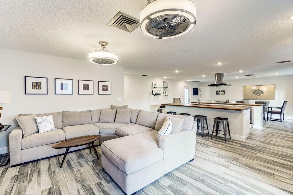 2594 Marcinski Road Jupiter, FL 33477 - Photo 2 of 10 a living room with furniture kitchen view and a wooden floor