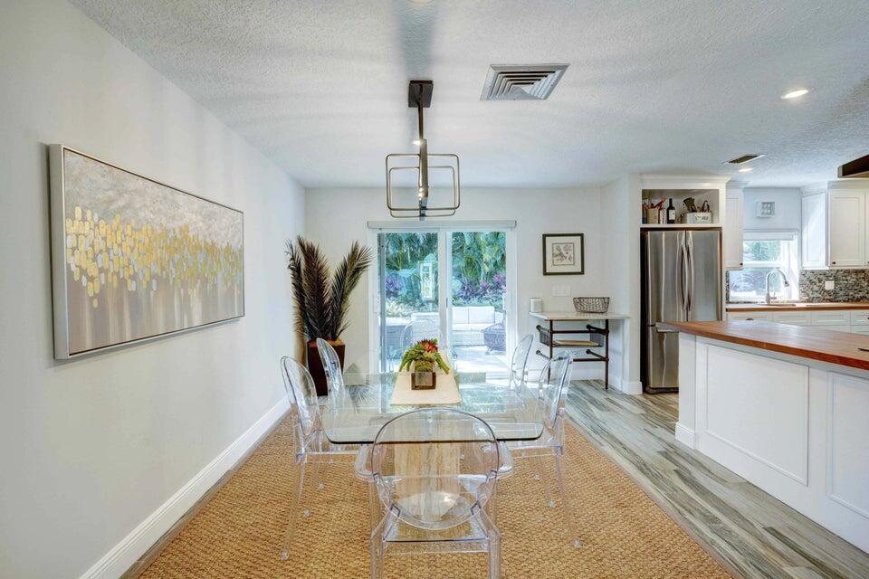 2594 Marcinski Road Jupiter, FL 33477 - Photo 6 of 10 a living room with furniture large window and painting on the wall