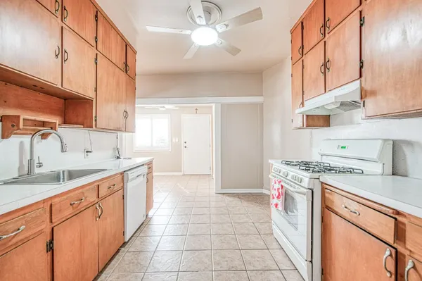 a kitchen with a sink cabinets and appliances