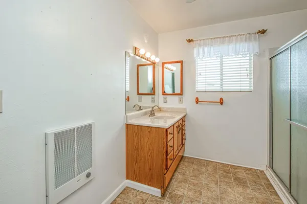 a bathroom with a sink a mirror and a shower