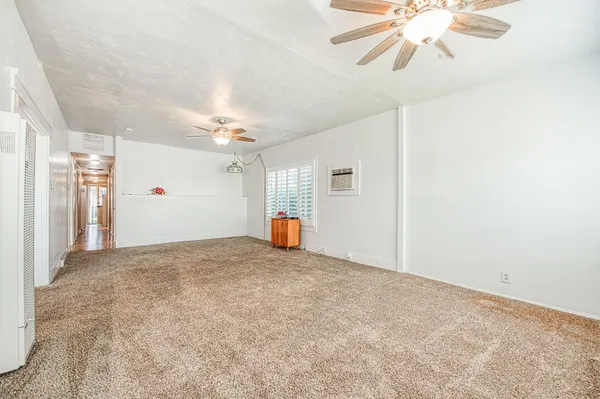 a view of empty room with a ceiling fan