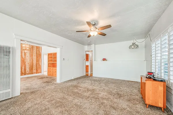 an empty room with closet and fan