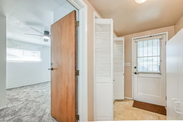 a view of a livingroom with wooden floor and windows