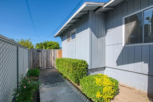 a view of a porch with furniture and garden