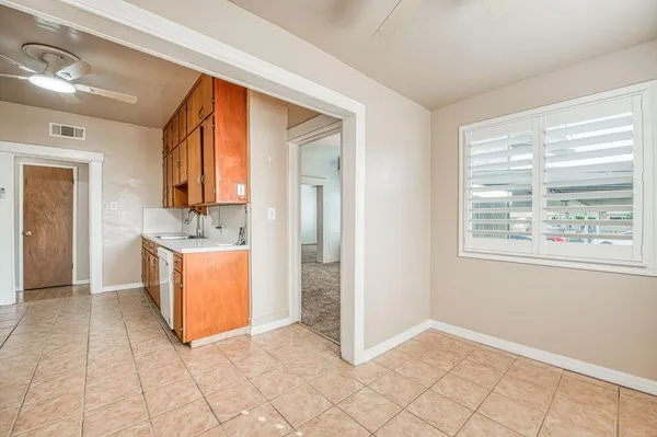 a view of kitchen with granite countertop cabinets and sink