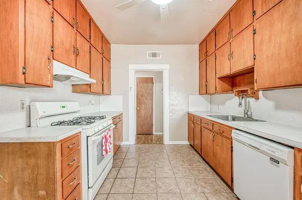 a kitchen with a sink stove and cabinets
