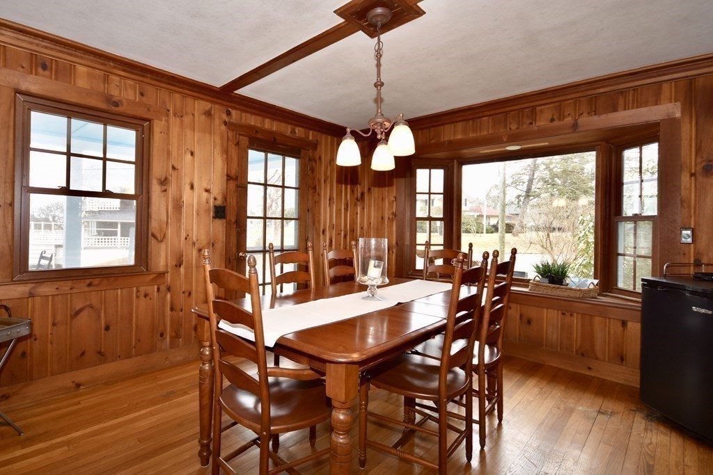 460 Williston Road Bourne, MA 02562 - Photo 12 of 37 a view of a dining room with furniture large windows and wooden floor