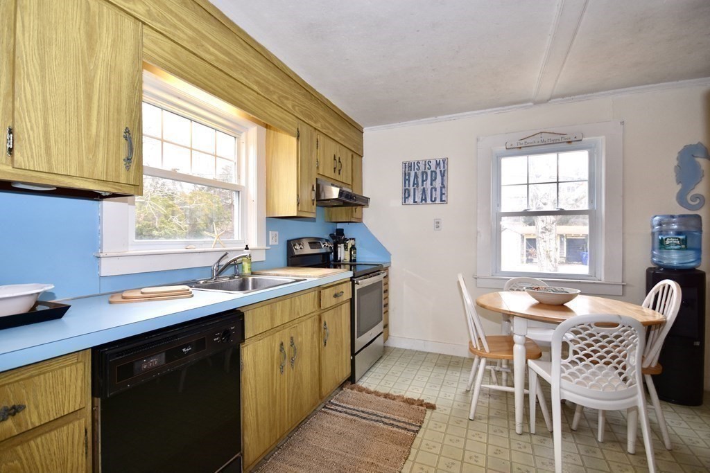 460 Williston Road Bourne, MA 02562 - Photo 15 of 37 a kitchen with a sink table and chairs