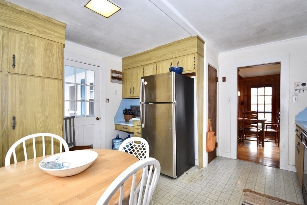 460 Williston Road Bourne, MA 02562 - Photo 16 of 37 a kitchen with stainless steel appliances granite countertop a refrigerator a sink a stove and island