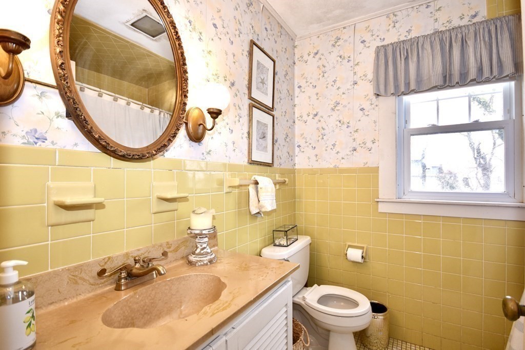460 Williston Road Bourne, MA 02562 - Photo 20 of 37 a bathroom with a sink a mirror and a toilet