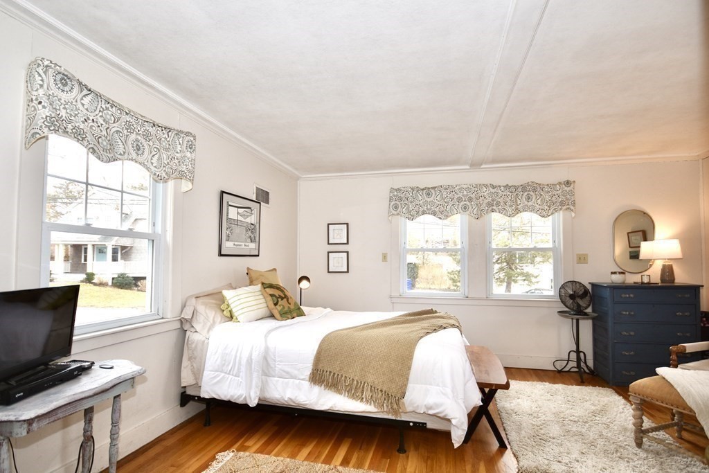 460 Williston Road Bourne, MA 02562 - Photo 21 of 37 a bedroom with a bed and wooden floor
