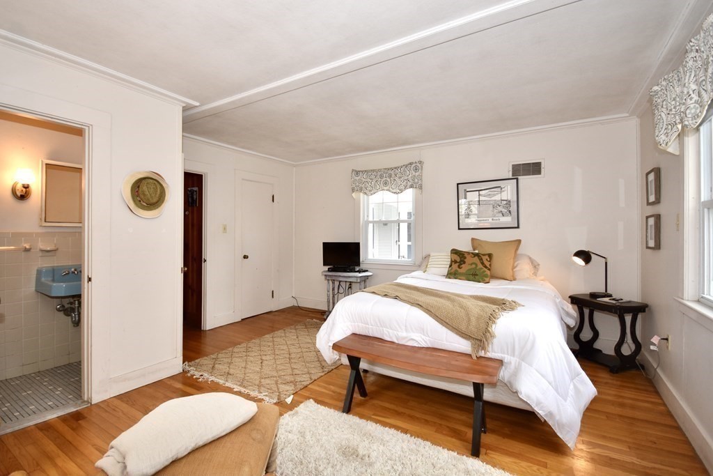 460 Williston Road Bourne, MA 02562 - Photo 23 of 37 a bedroom with a bed and wooden floor