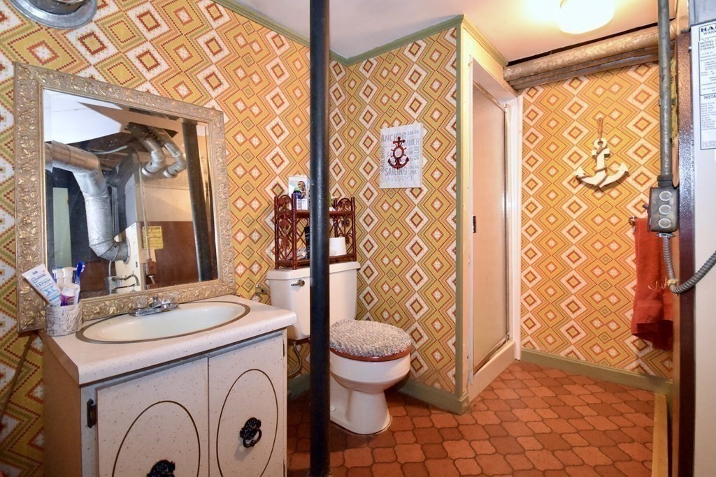 460 Williston Road Bourne, MA 02562 - Photo 30 of 37 a bathroom with a sink a toilet and a mirror