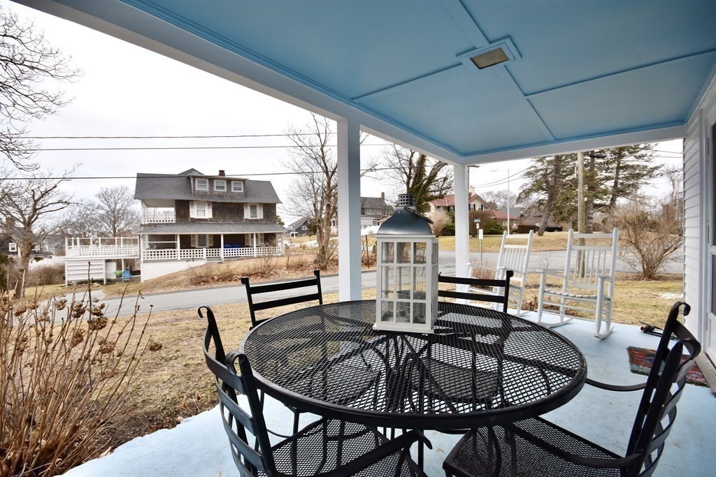 460 Williston Road Bourne, MA 02562 - Photo 32 of 37 a dining room with furniture a chandelier and wooden floor