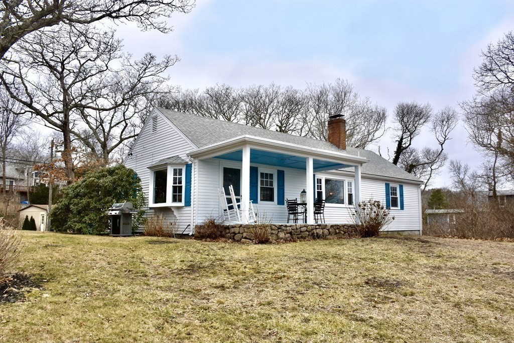 460 Williston Road Bourne, MA 02562 - Photo 6 of 37 a front view of house with yard and trees around